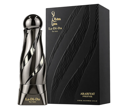 La-Di-Da for him Arabiyat Prestige perfume bottle in a polished metallic silver finish, standing next to its black and gold textured packaging box on a white background.