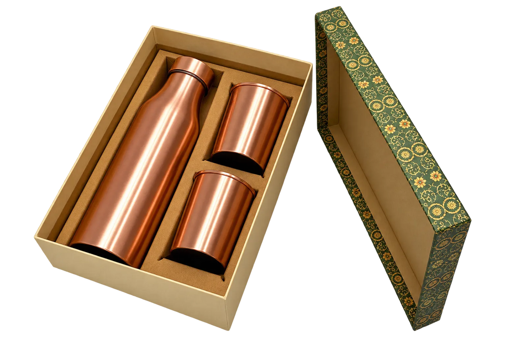 A copper-colored water bottle and two matching tumblers presented in a beige gift box, with the patterned outer lid placed beside the box on a white background.